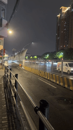 Rainy night pedestrian activity observed in Shanghai's Yangpu District