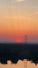 Sunset observed over rural Noviy, Russia with power infrastructure