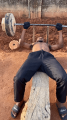 Man exercises with makeshift equipment in outdoor Bukuru workout