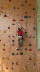 Children practice indoor rock climbing at Izhevsk gym