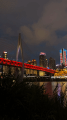 Chongqing's illuminated skyline and red bridge captured at night