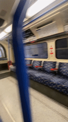 Empty London Underground carriage documented during afternoon journey