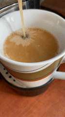 Coffee machine fills striped mug in Dronten morning routine