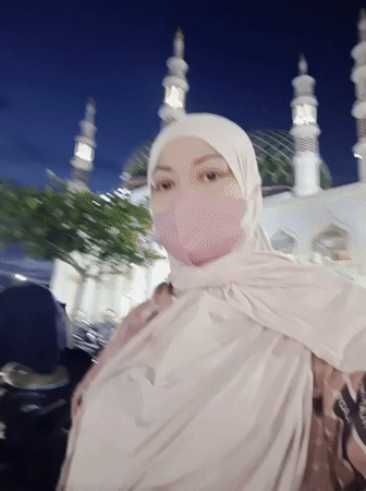 Nighttime gathering at an illuminated mosque in Kotapantonlabu