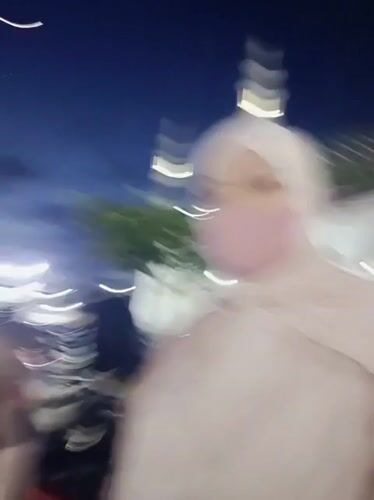 Nighttime gathering at an illuminated mosque in Kotapantonlabu