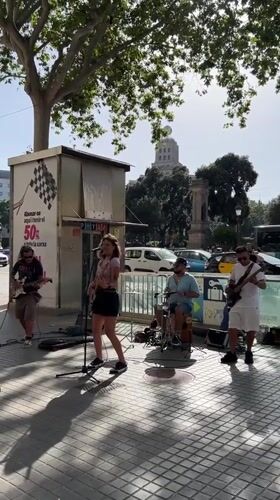 Street music and foot traffic fill central Barcelona on a sunny afternoon