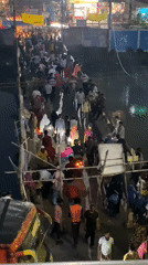Crowds cross makeshift bamboo bridge over Dhaka river