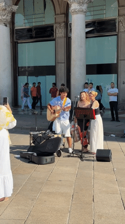 Live music and street life outside Milan's Duomo
