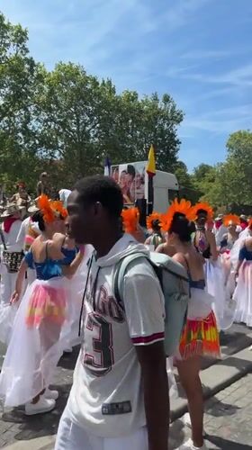 Carnival parade with costumed dancers and brass band, Paris