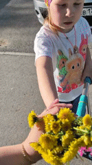Family gathering dandelions during spring outing in Tobolsk, Russia