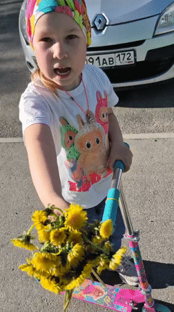 Family gathering dandelions during spring outing in Tobolsk, Russia