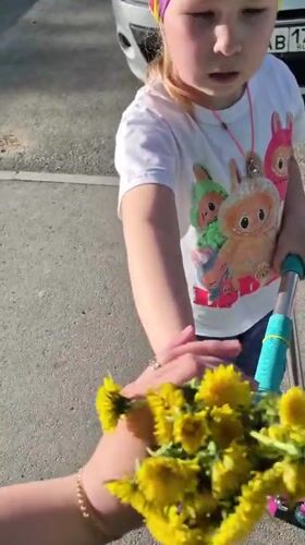 Family gathering dandelions during spring outing in Tobolsk, Russia