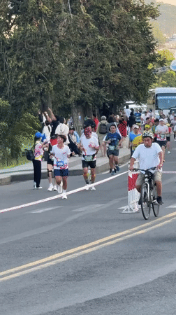 Marathon runners compete along lakeside streets in Da Lat