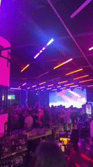 Late night clubbing scene in Sofia with DJ and dancing crowd