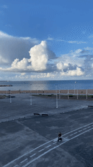 Partly cloudy evening captured at Gijón waterfront area
