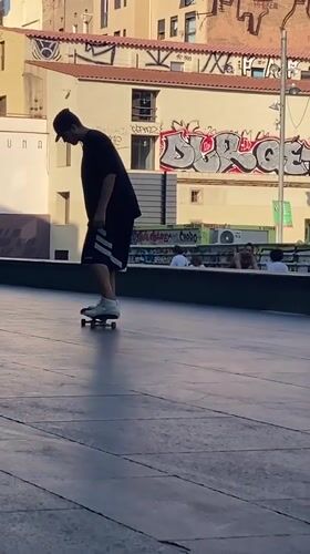 Skaters running tricks in a Barcelona plaza on a summer afternoon