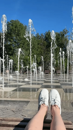 Person sits by decorative fountain in Kazan