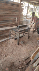 Woodworker operates table saw in Nigerian workshop