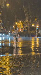 Heavy rainstorm soaks Barcelona streets, creates reflective urban nightscape