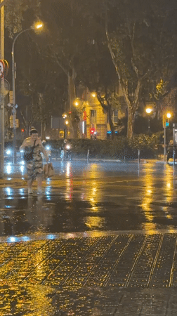 Heavy rainstorm soaks Barcelona streets, creates reflective urban nightscape
