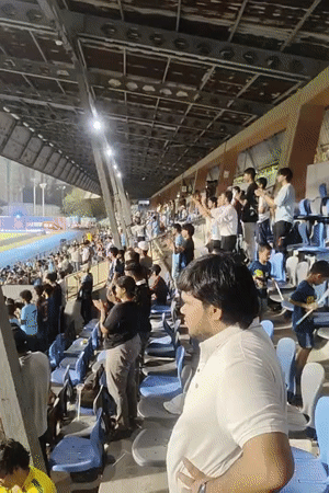 Soccer fans celebrate at Mumbai stadium during evening match