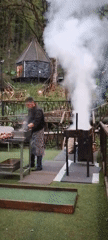 Outdoor kebab grilling operation in Russian forest setting