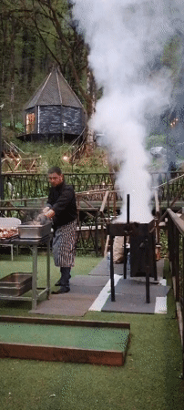 Outdoor kebab grilling operation in Russian forest setting
