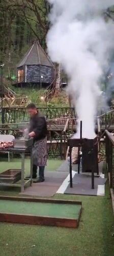 Outdoor kebab grilling operation in Russian forest setting