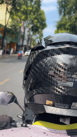 Motorcycle rider takes morning coffee break in Nha Trang