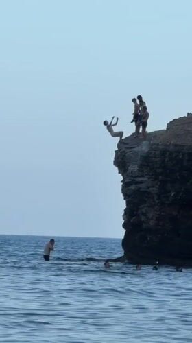 Cliff jumping into the Adriatic near Budva on a clear day