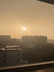 Rainy afternoon cityscape observed through windows across urban area