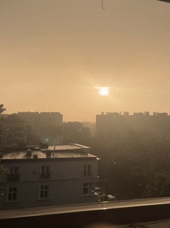 Rainy afternoon cityscape observed through windows across urban area