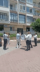 Brass band, blooming oleanders, and street life in Yenişehir