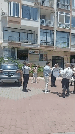 Brass band, blooming oleanders, and street life in Yenişehir