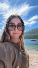 Woman photographed on Montenegro waterfront promenade under clear skies
