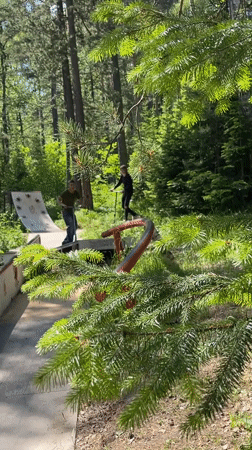 Scooter tricks at a forest skate park in Divnogorsk