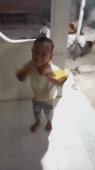 Quiet morning at home: a kid, a tiled floor, and a meal