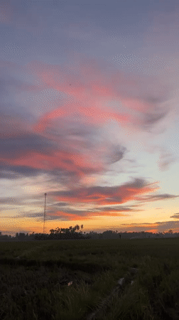 Vivid sunset colors paint the sky over Dayah Baroh, Indonesia