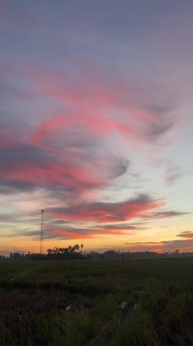 Vivid sunset colors paint the sky over Dayah Baroh, Indonesia