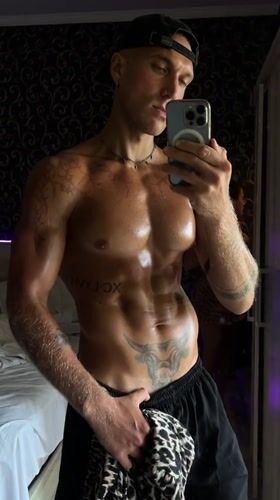 Tattooed mirror selfie session in a North Kuta bedroom