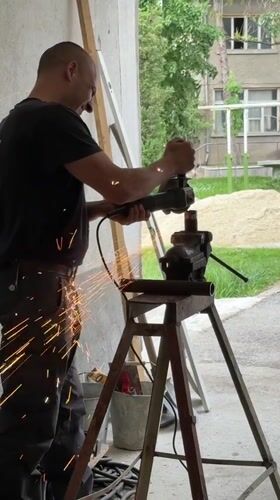 Worker grinds metal pipe in Kazanlak workshop