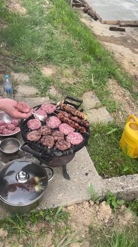 Backyard BBQ documented at wooden cabin in rural Bulgaria