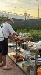 Moscow outdoor culinary event features roasted meat, luxury cars