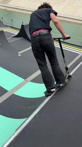 Scooter rider performs tricks on ramp course in Montpellier