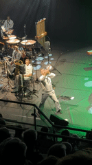 Brass band in naval whites performs lit stage show in Eksjö
