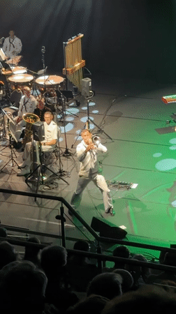 Brass band in naval whites performs lit stage show in Eksjö