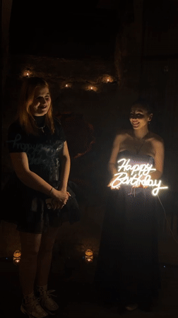 Birthday celebration captured in dimly lit Varna setting