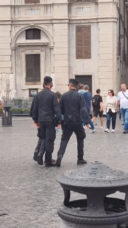 Tourists photograph Four Rivers fountain in Rome's Piazza Navona
