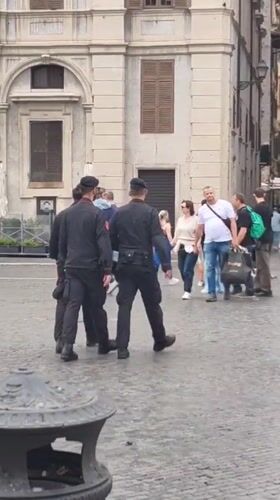 Tourists photograph Four Rivers fountain in Rome's Piazza Navona