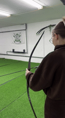 Woman practices archery at indoor range in Naberezhnye Chelny